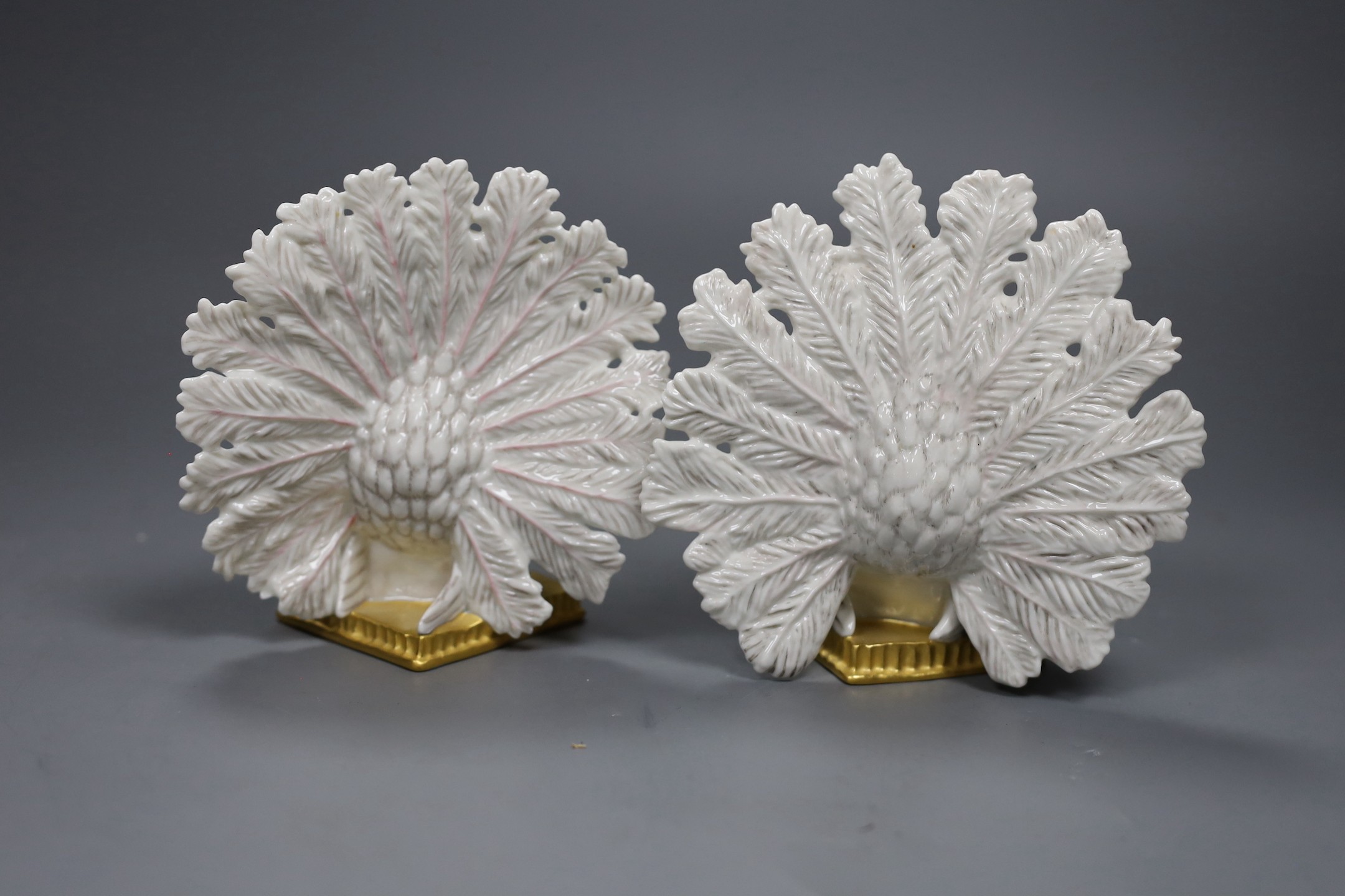 A pair of Nymphenberg porcelain figures of peacock tailed doves, 13cm tall